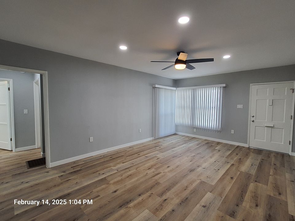 Living room looking towards hallway and apartment entrance