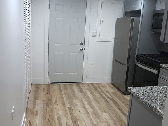 Newly remodeled kitchen with back entrance door. Room for a small table