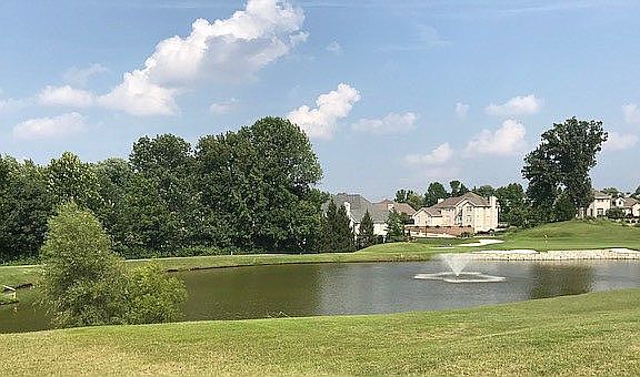 To right of back of house.