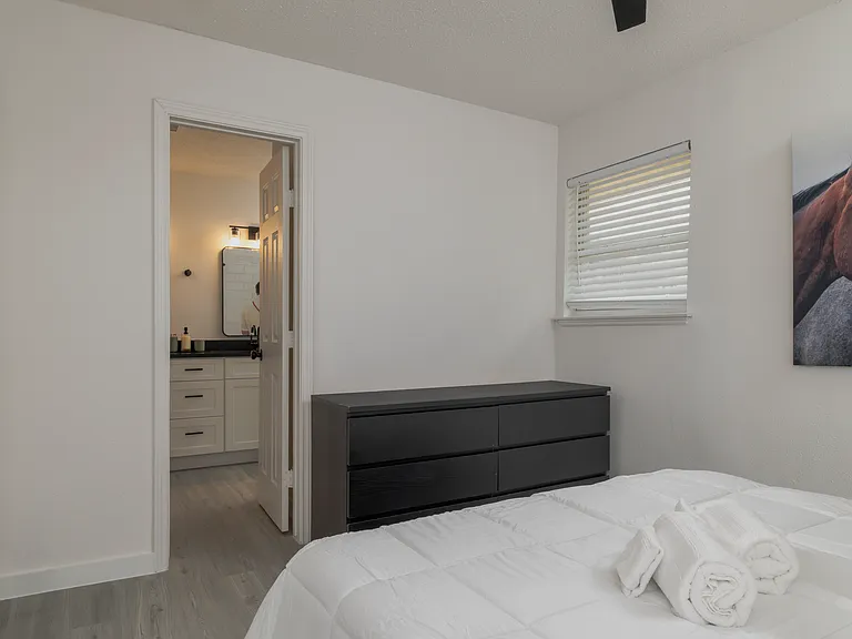 Bedroom #1 with attached full bath and queen bed.
