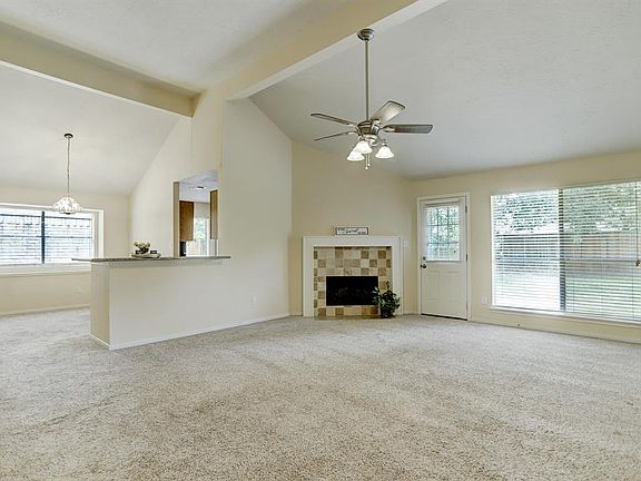 This home is open concept, the family room is open to the breakfast room, separated only by a long granite covered breakfast bar. Notice how the corner fireplace is a focal feature of the room.