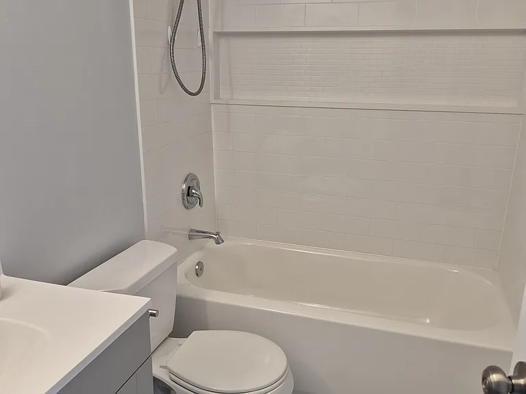 Remodeled Bathtub/shower and surround with toiletries shelf. New LVT flooring.