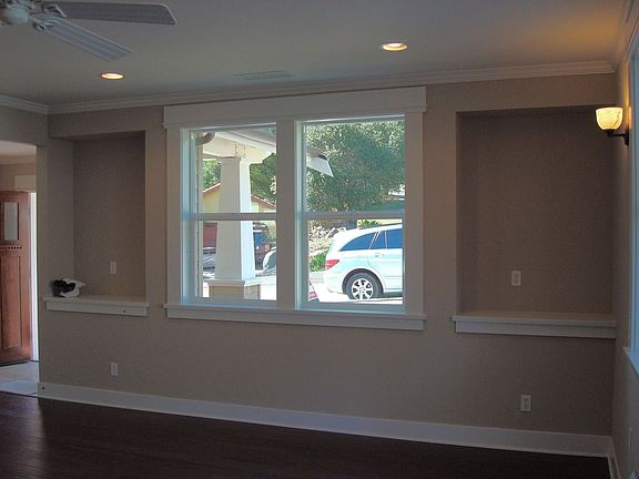 Another view of living room w/display niches, recessed lighting, ceiling fan