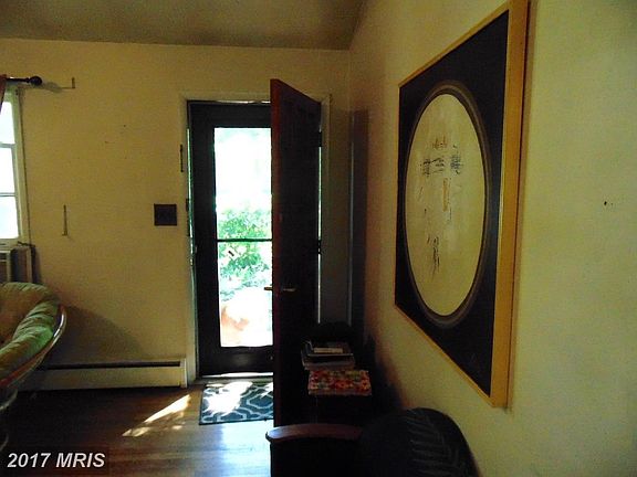 Foyer into living room with hardwood floors