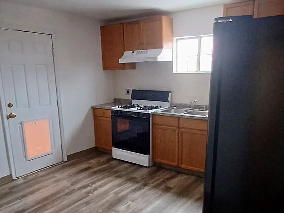 Kitchen and back door that leads to fenced yard.