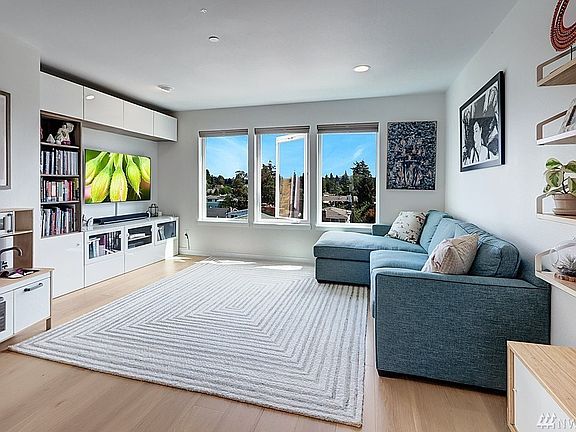 Expansive Living Room w/ Oversized Windows & Privacy Blinds
