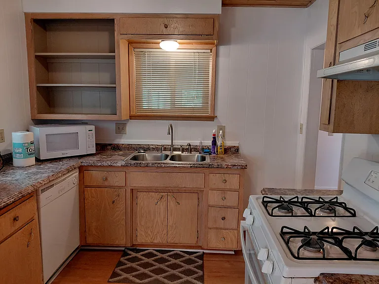 Full kitchen with dishwasher, gas range, and new refrigerator.