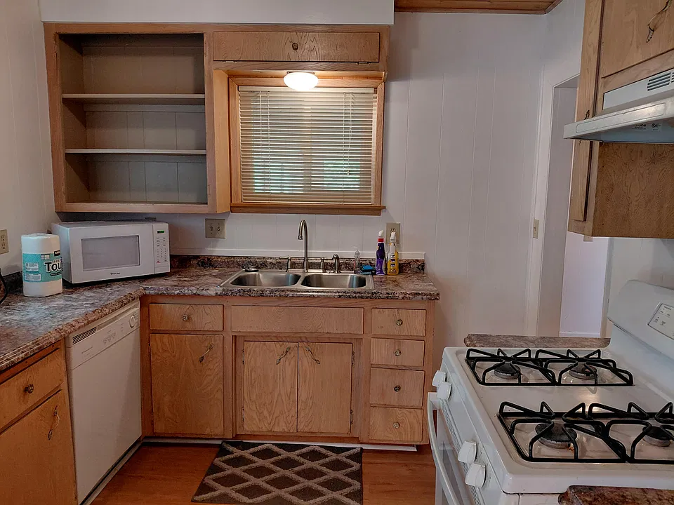 Full kitchen with dishwasher, gas range, and new refrigerator.