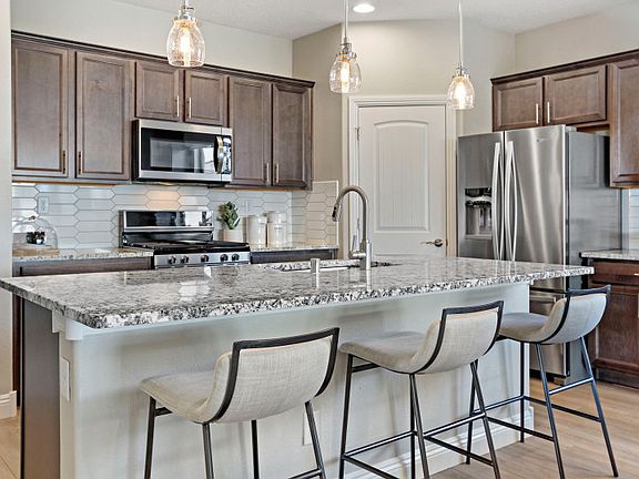 Kitchen offers plenty of cabinet space and a large corner pantry.