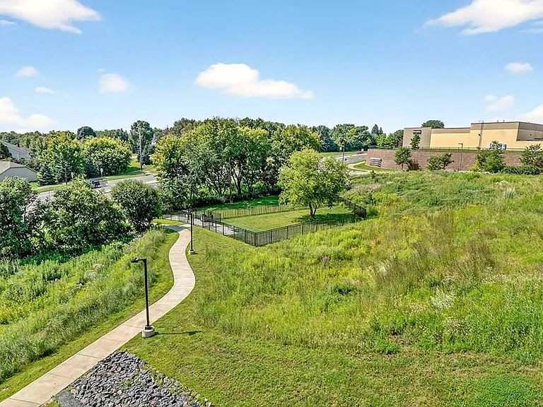 Scenic walking paths and open green space create a peaceful setting for daily strolls and fresh air just outside your door.