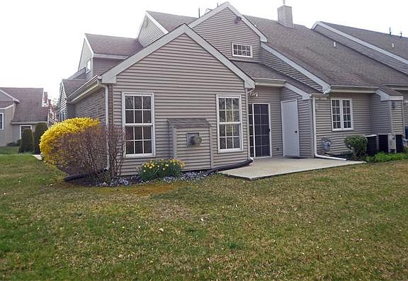 View of patio and rear of home from walking path