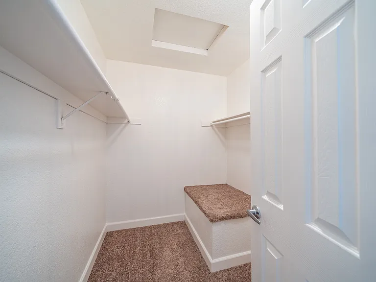 Walk in master bedroom closet.