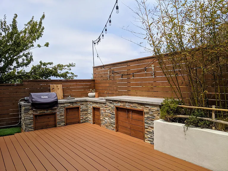 Rear deck - outdoor kitchen with natural gas grill and burner, sink, and ample storage.