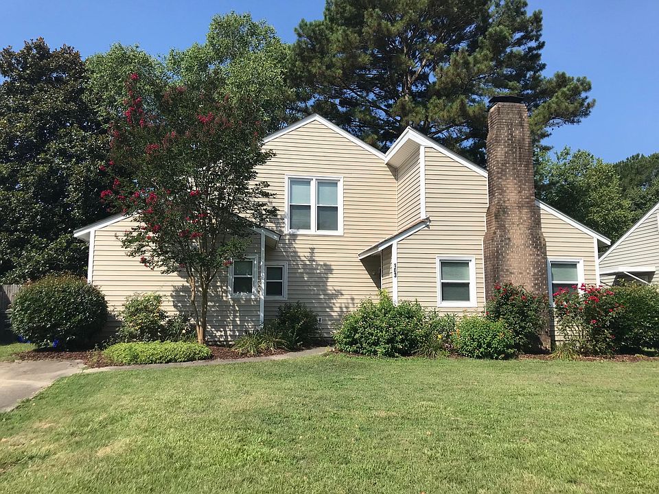 Front yard with flowering shrubs.