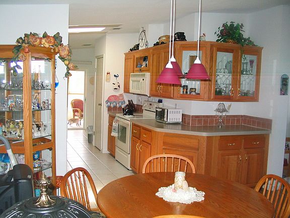 Front door entry looking into dining area, kitchen
