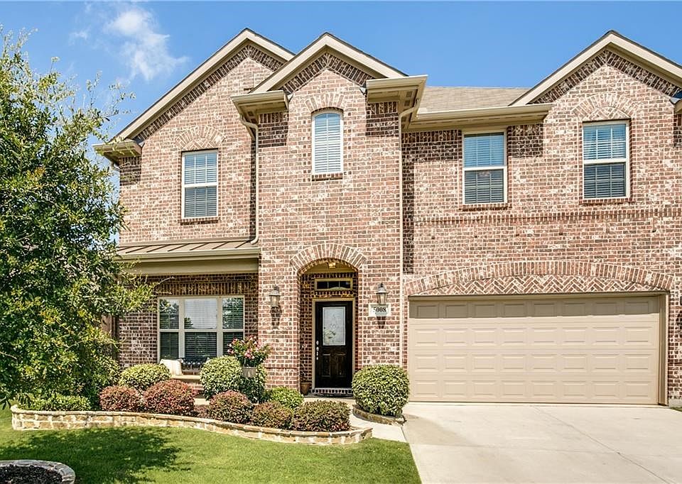 Welcome to 5008 Seashore Lane in The Shores of Hidden Cove. Gorgeous curb appeal with professional landscaping, lovely carriage light fixtures and herringbone brick accents.