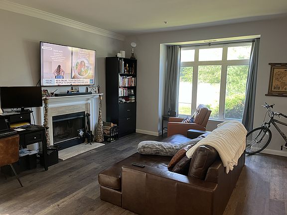 Great room with large bay windows with lots of sunlight, and wood burning fireplace.