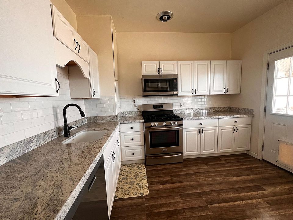 Kitchen with new granite countertops and plenty of storage cabinets.
