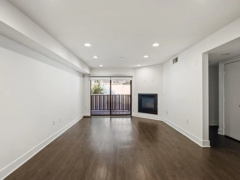 Living Room with Electric Fireplace, Recessed Lighting, Vinyl Flooring, and Patio