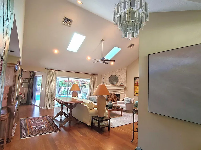 Spacious faulted living room, original art and tasteful furnishings. Wood floors throughout.