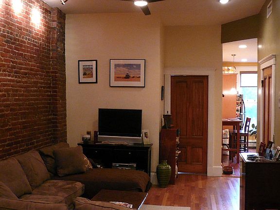 Open loft like living room: Exposed brick ; 12' ceilings