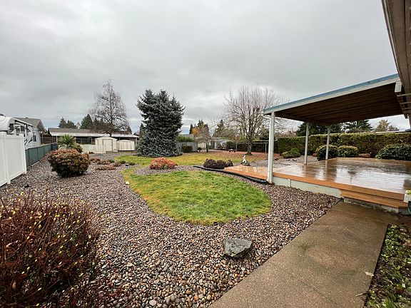 Angle corner view of back fully landscaped yard with in ground irrigation system.