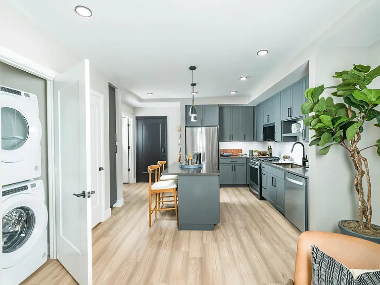Modern design meets everyday convenience_featuring sleek cabinetry, stainless steel appliances, and in-home laundry to simplify your routine.