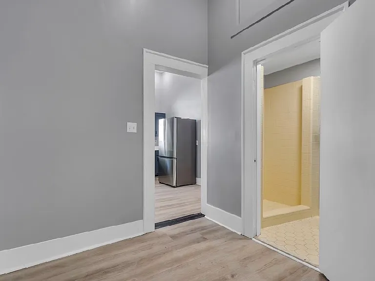 Main hallway forks to either the kitchen (left) or the bathroom (right)