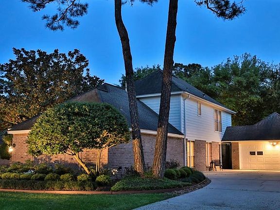 METICULOUS & PROFESSIONALLY LANDSCAPED ON A WOODED LOT - The home has had all siding on the back of the house and the garage replaced with hardi-plank.