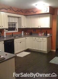 Kitchen : New cream-colored cabinets, quartz countertops, and birch hardwood flooring.