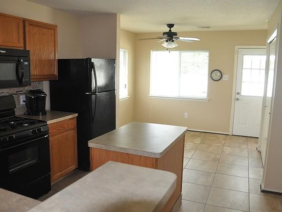 Island kitchen with ceiling fan