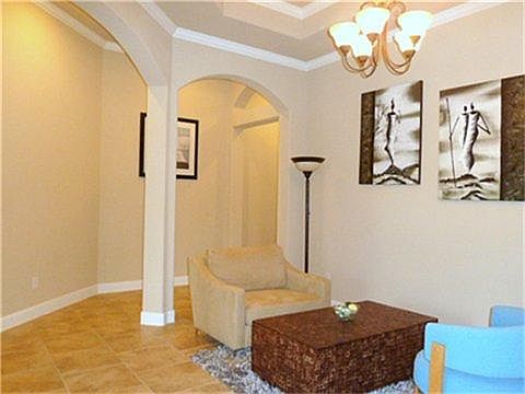 Vaulted ceiling with arches and crown moldings.