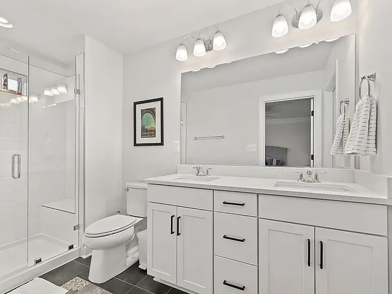 En suite-bath, QUARTZ dual vanity, tile shower, sunlight window + shower bench