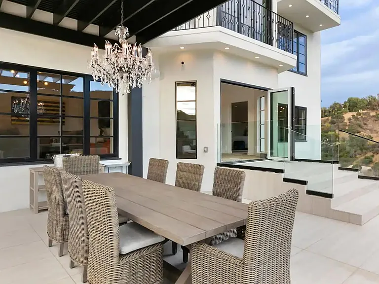 Exquisite outdoor dining table with combination of old and new world design touches.