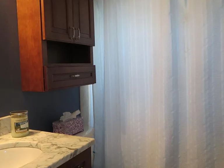 Fully remodeled bathroom with custom cabinets and marble vanity