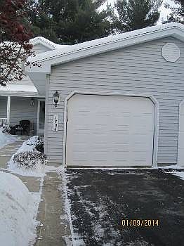 The 1.5 car oversized garage has extra room for additional storage.  There is a walk way leading up to front entrance of the home.