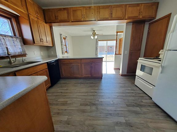 Kitchen with new cabinets and countertops, furnished with stove, refrigerator, dishwasher, and Culligan drinking water filter system (11'x13')