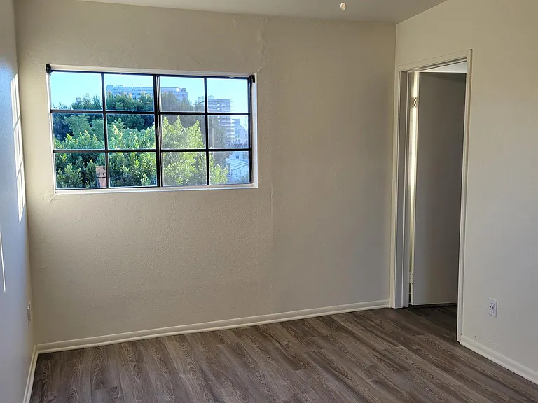 Bedroom #2 with window view of Hollywood Skyline and Bathroom Entry Door
