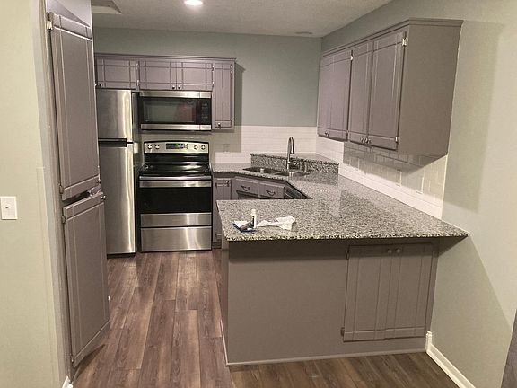 Granite countertops, stainless steel appliances, and large pantry in the kitchen