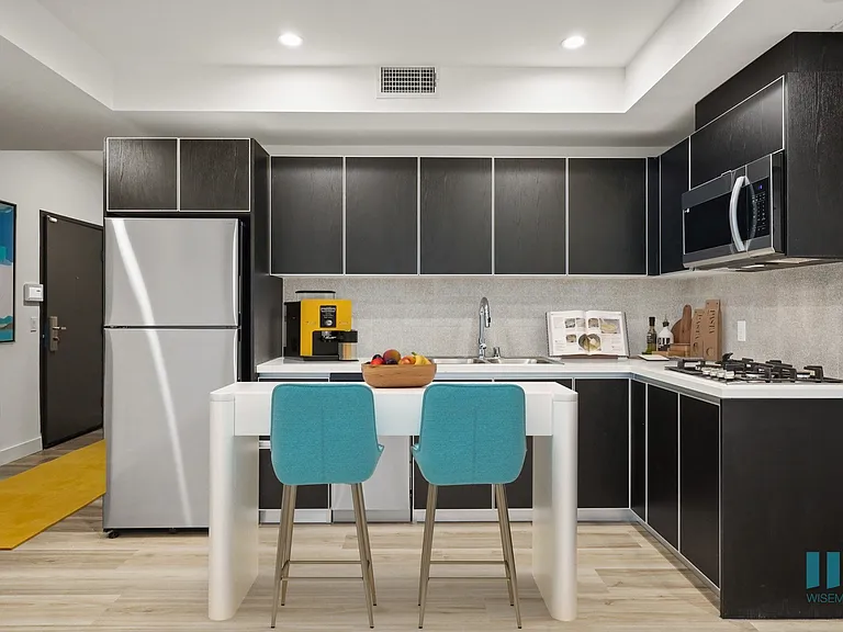 Open-Concept Kitchen with a Stainless-Steel Refrigerator, Dishwasher, Stove Range, and Microwave Oven - Redwood Floor Plan