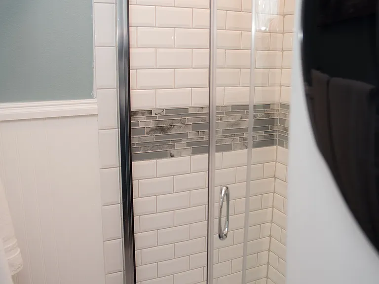 Bright vanity area with a wood-toned cabinet and extra storage for your toiletries.
