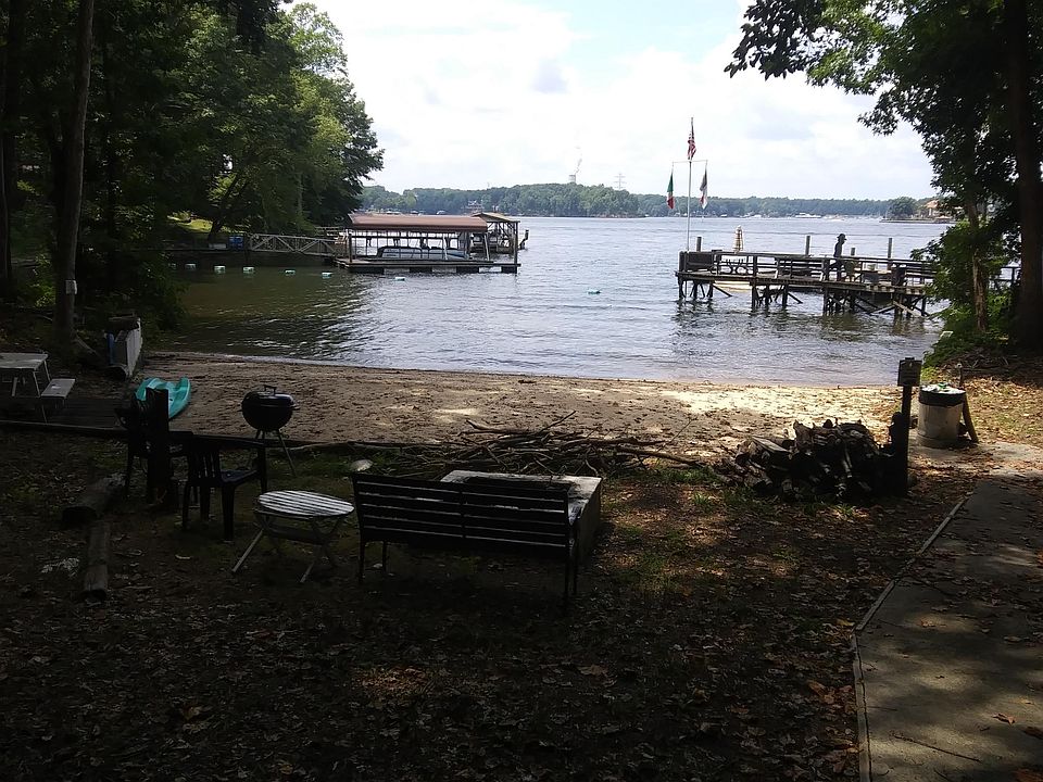 THIS IS THE BIGGEST BEST PRIVATE SANDY BEACH ON LAKE NORMAN. WE HAVE PIERS GOING OFF BOTH SIDES OF THE COVE AND A SAFETY LINE RUNNING ACROSS THE COVE FROM PIER TO PIER. THERE IS A FIRE PIT THIS SIDE OF THE SEAWALL W/ BENCH, CHAIRS AND A COCKTAIL TABLE.
