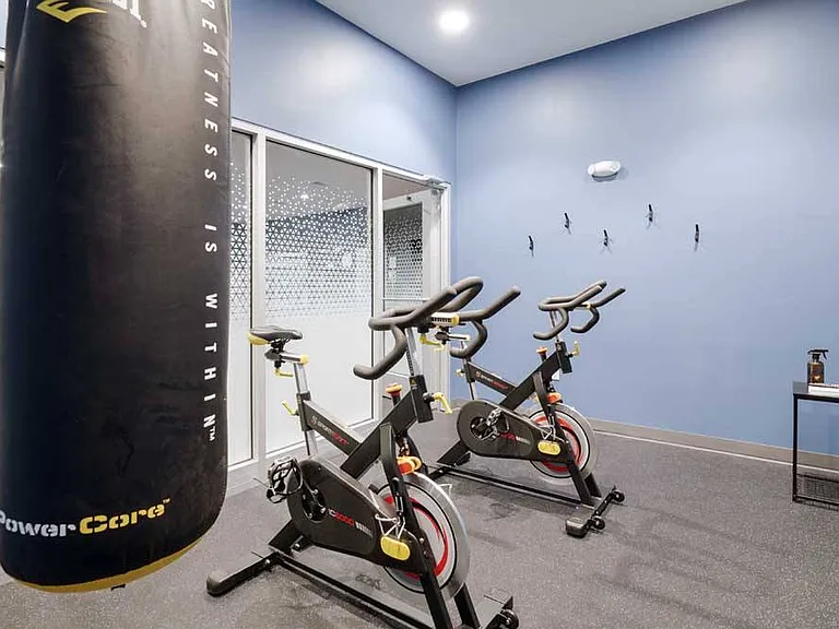 A dedicated yoga and spin space make it easy to start the morning with movement or recharge after a full day.