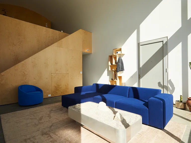 Living room with couch and art deco sculptures, couch and chair