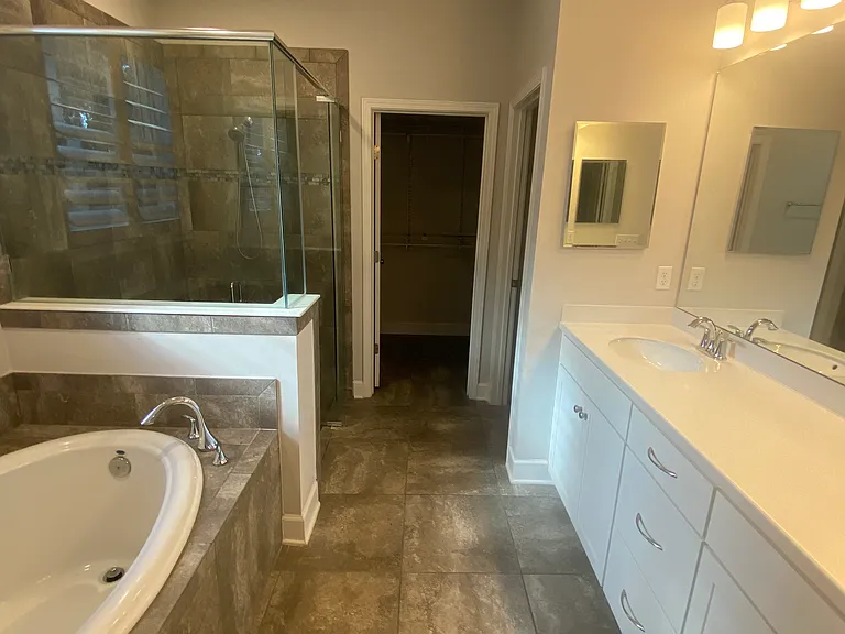 Master bathroom, tub, shower, and vanity
