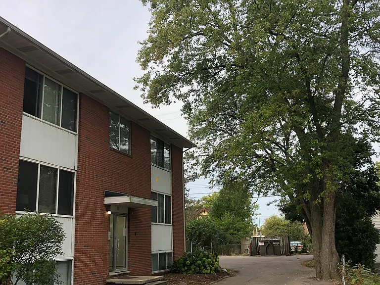 Building and parking lot, showing secure entrance to get into building.