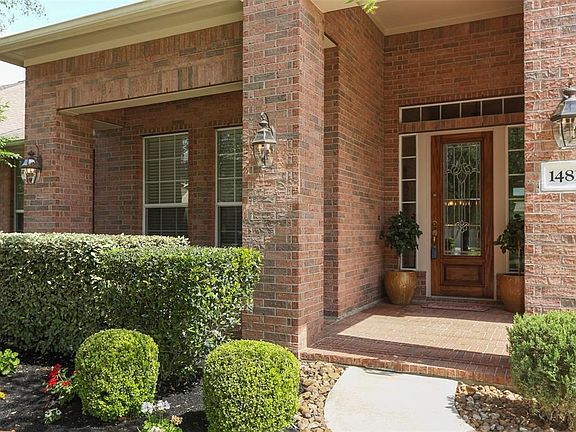 Nicely manicured flower beds enhance the curb appeal as you approach the glass front door.
