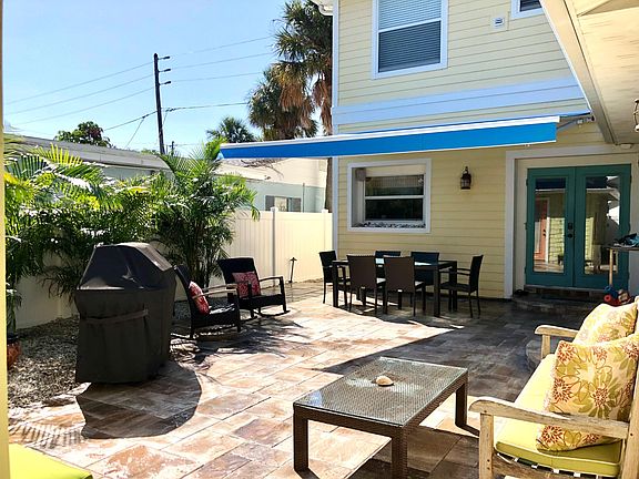 Backyard with plenty of seating. Accessed by kitchen and master bedroom suite. New awning provides great shade!