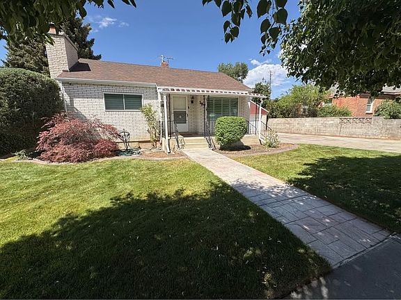 Enjoy a relaxing view from the picture window, where park strip trees create a peaceful, private backdrop that makes the home feel like its own little world.