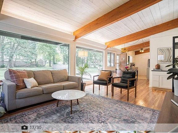 living room area leading to dining and kitchen areas
